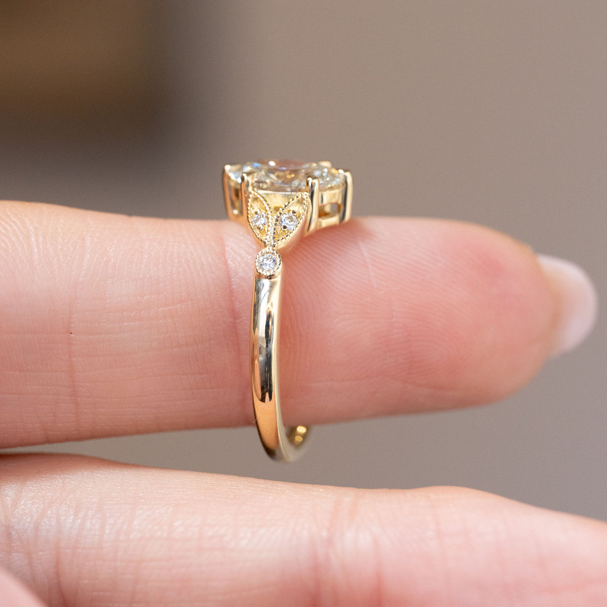 Profile view showing the open gallery, diamond accents and polished yellow gold shank.