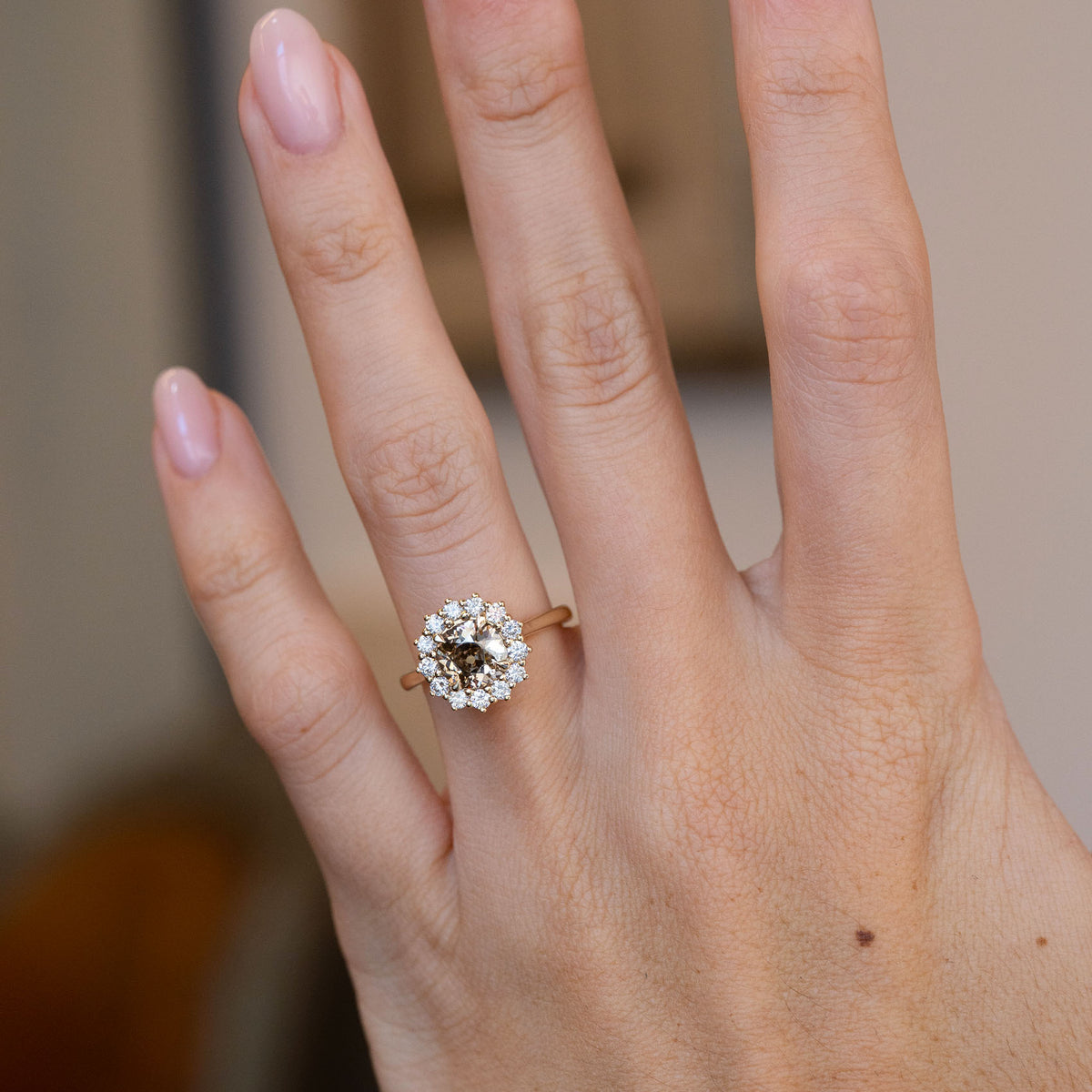 Antique-inspired brown diamond engagement ring worn on a hand, showcasing its elegant proportions and distinctive cluster design.