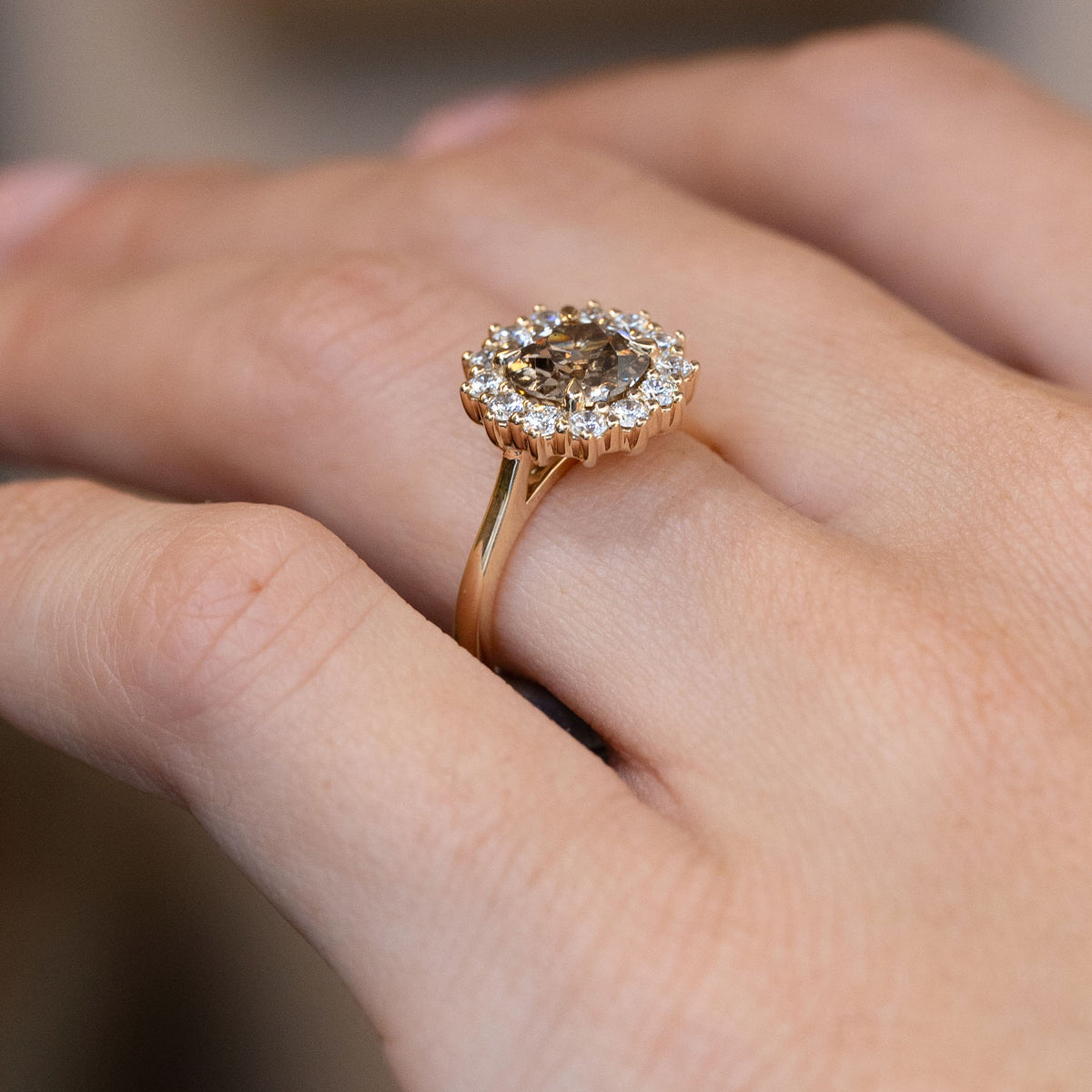 Side-angle view of the old-mine diamond cluster ring worn on a hand, highlighting the elevated setting and delicate gold band.