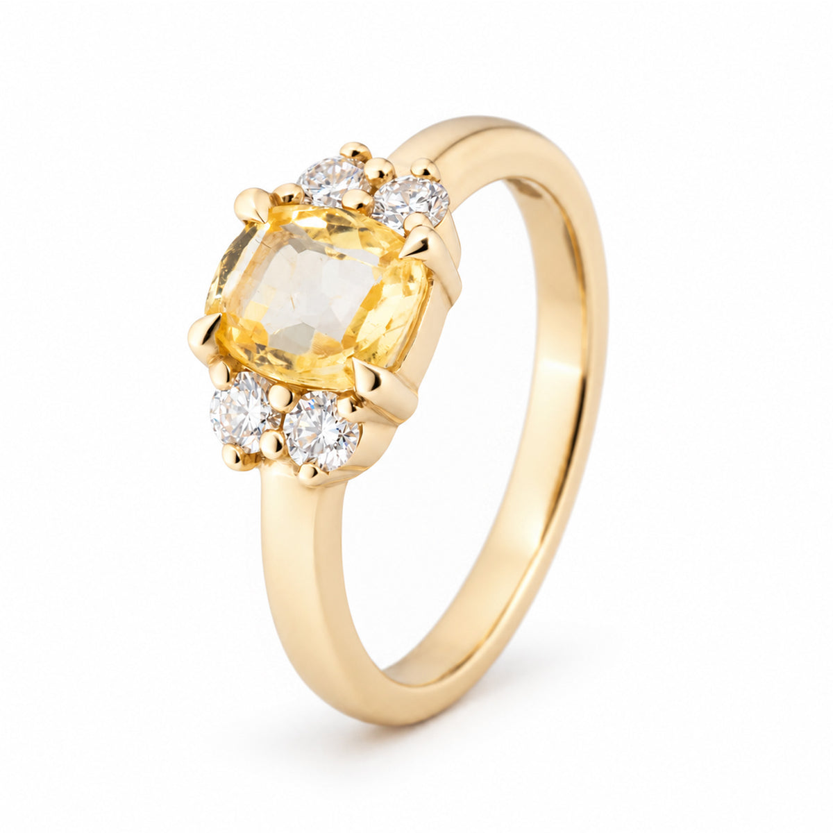 Angled studio view of a vintage-inspired yellow sapphire and diamond engagement ring, showcasing its cushion-cut gemstone, symmetrical diamond clusters and polished yellow gold band.