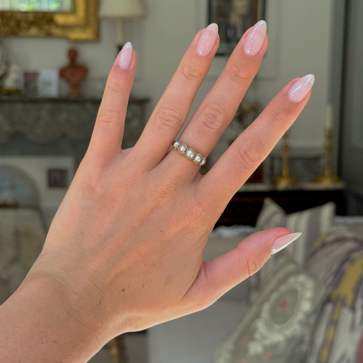 antique georgian pearl half hoop ring worn on hand, front view.