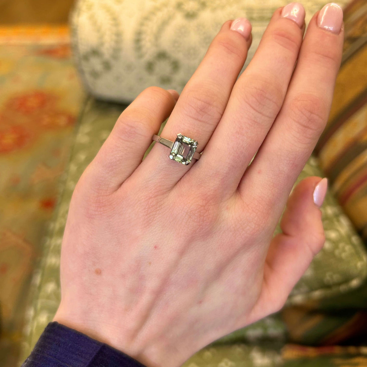 Green and brown colour-change sapphire solitaire engagement ring