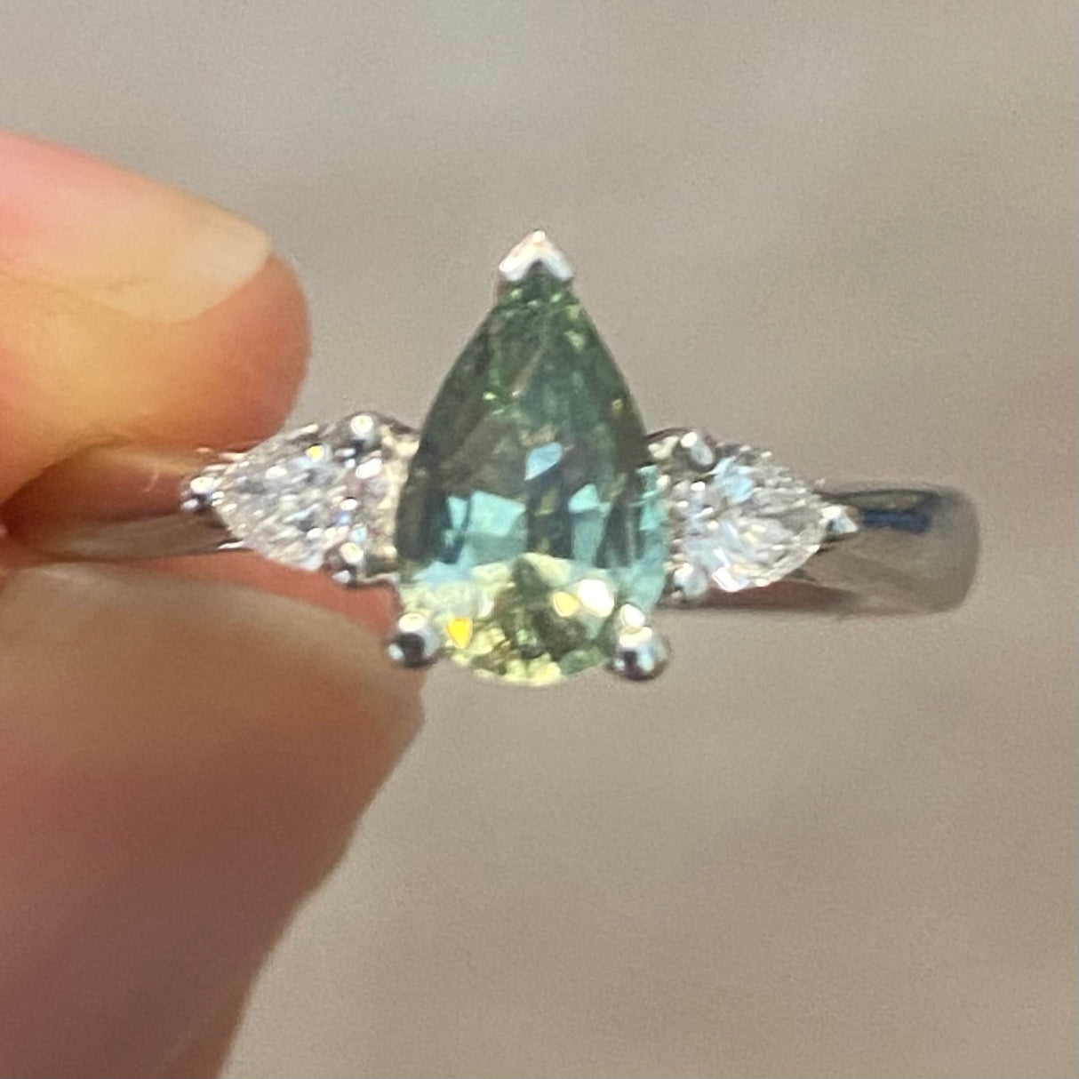 Pear-cut teal sapphire & diamond three-stone engagement ring