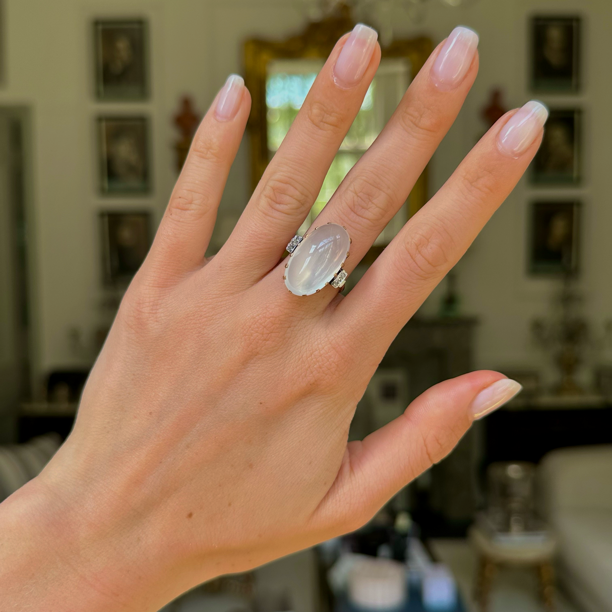 Moonstone and diamond ring, worn on hand. 