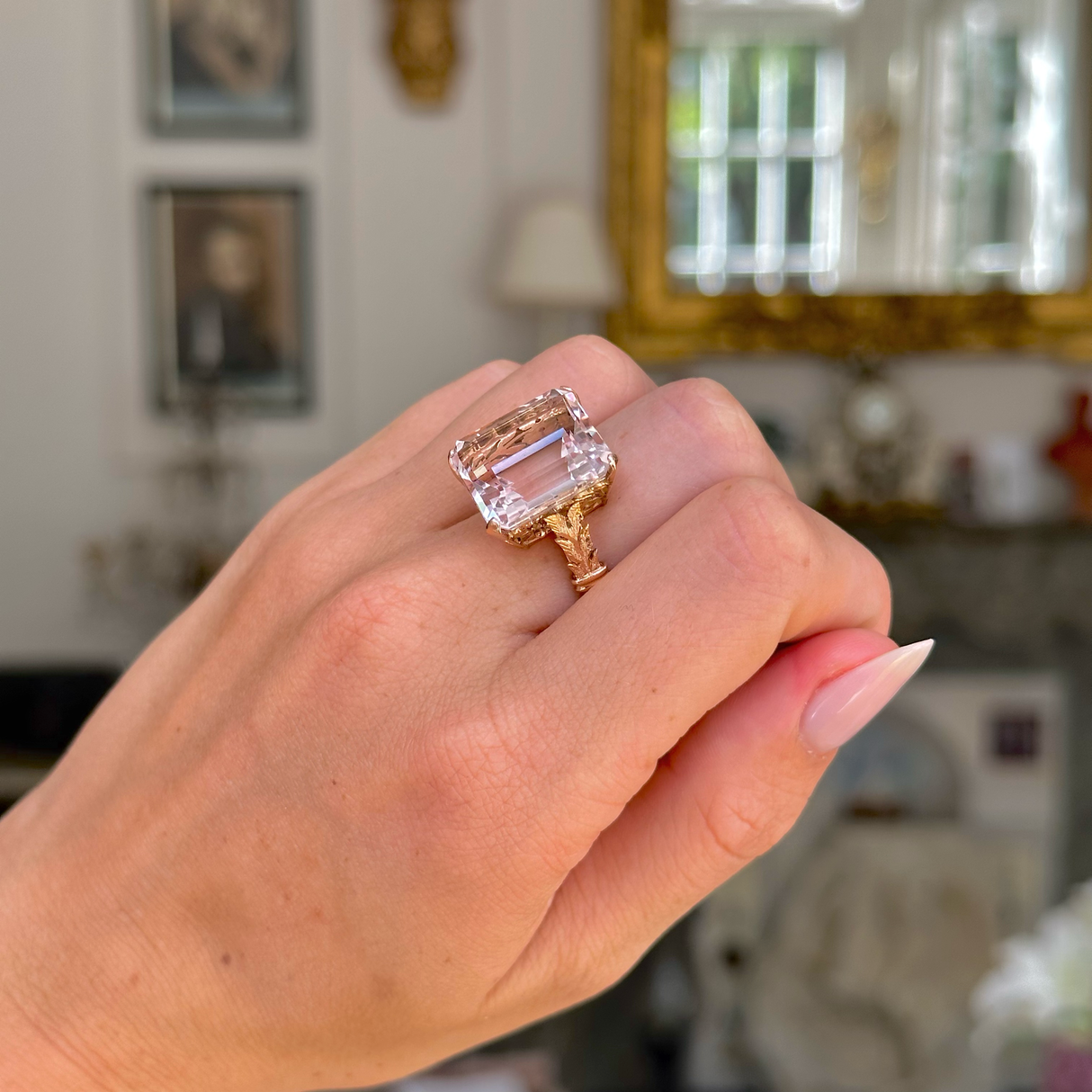 Morganite cocktail ring worn on closed hand. 