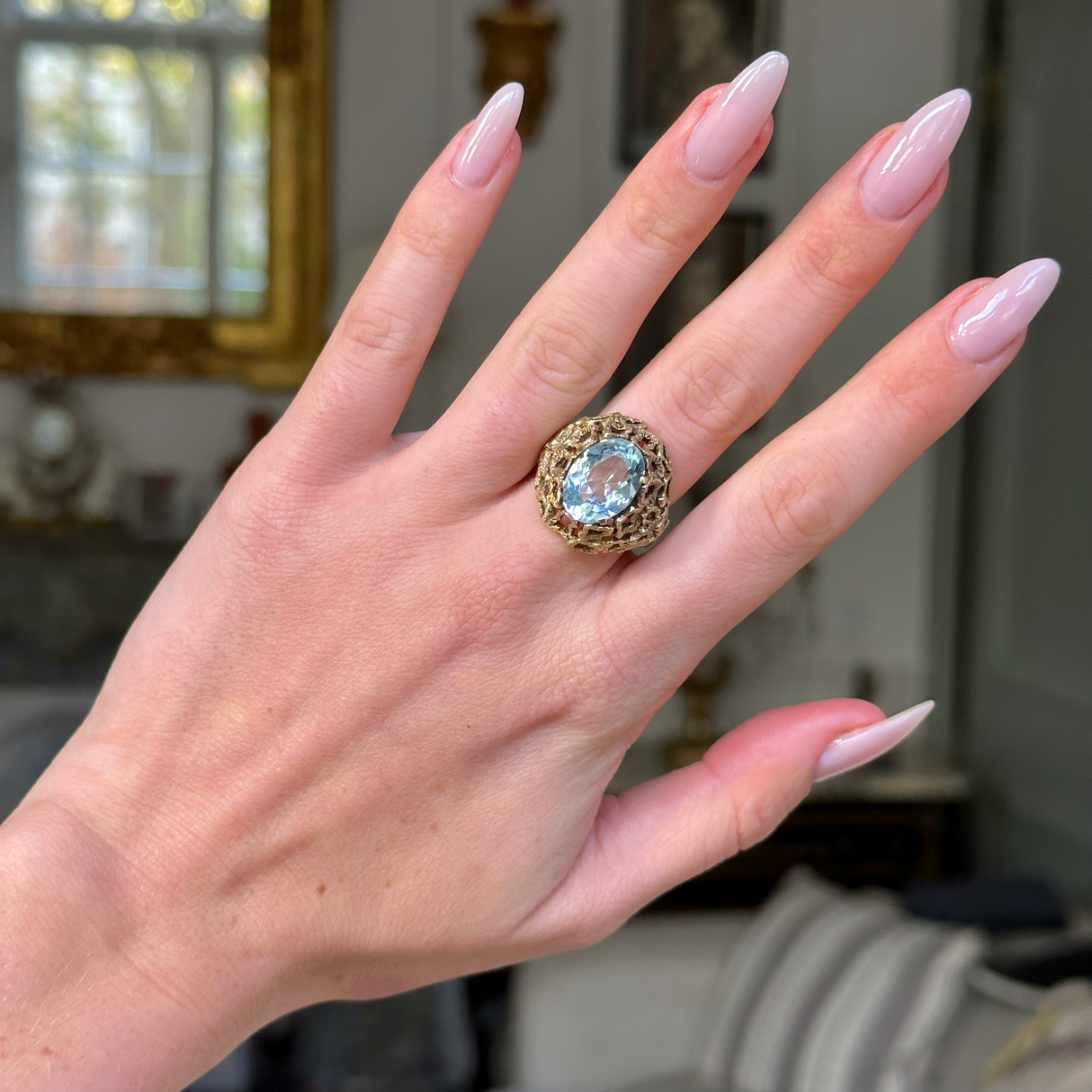 aquamarine ring with naturalistic textured yellow gold band on hand.