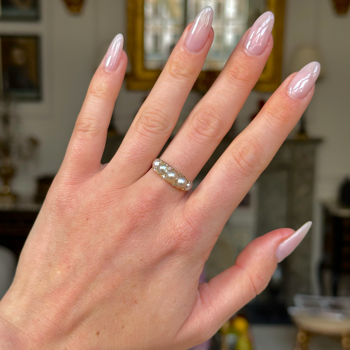 Georgian pearl half hoop ring worn on hand.
