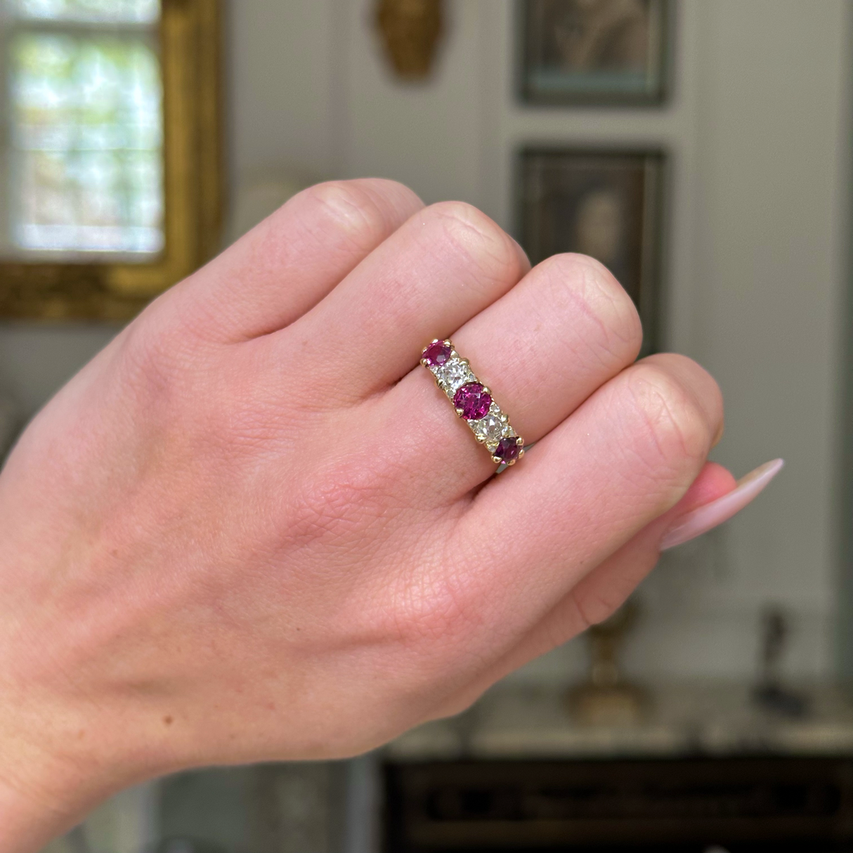 Antique, Edwardian five stone ruby and diamond ring, worn on closed hand.