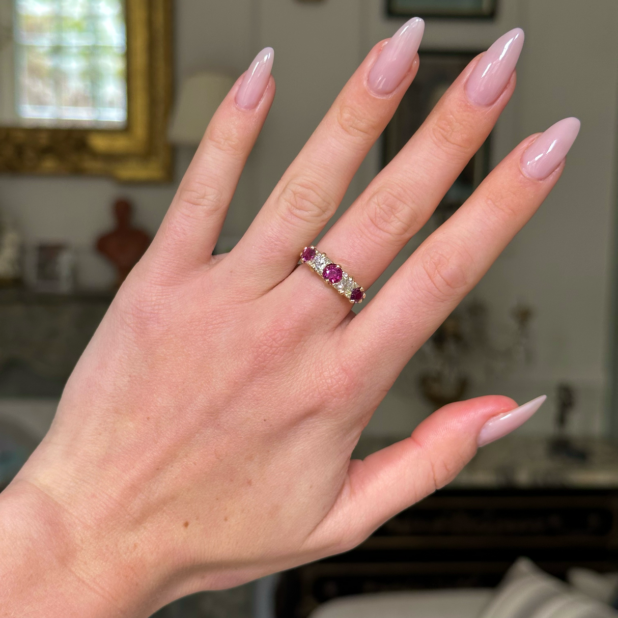 Antique, Edwardian five stone ruby and diamond ring, worn on hand.