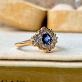 Sapphire and diamond cluster ring, side view.