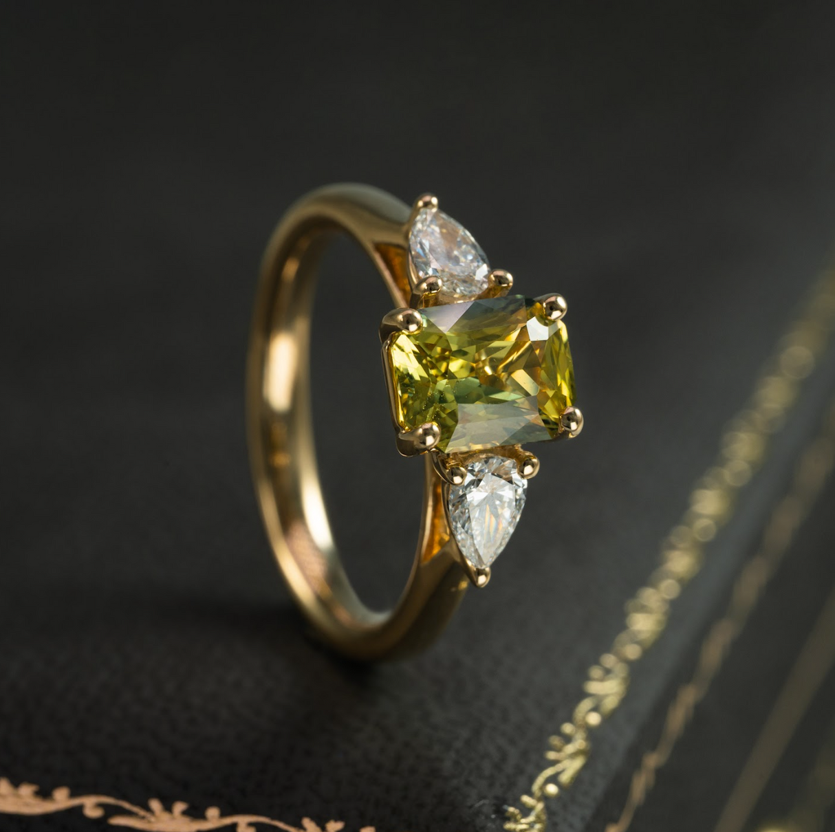 Emerald-cut yellow sapphire and diamond three-stone ring