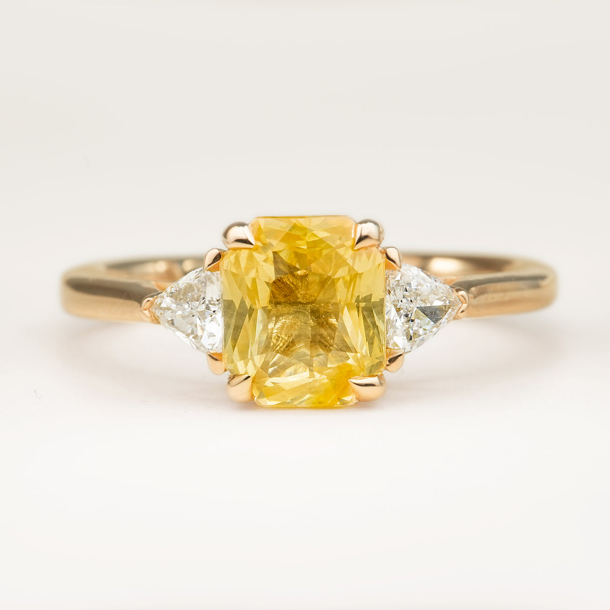 Yellow sapphire and diamond three-stone engagement ring
