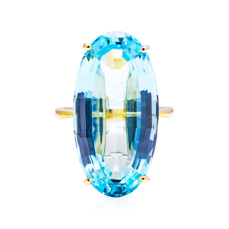 Large aquamarine and yellow gold cocktail ring on a white background, front of ring perspective. 