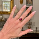 Red tourmaline and diamond cocktail ring, worn on hand, frontview. 