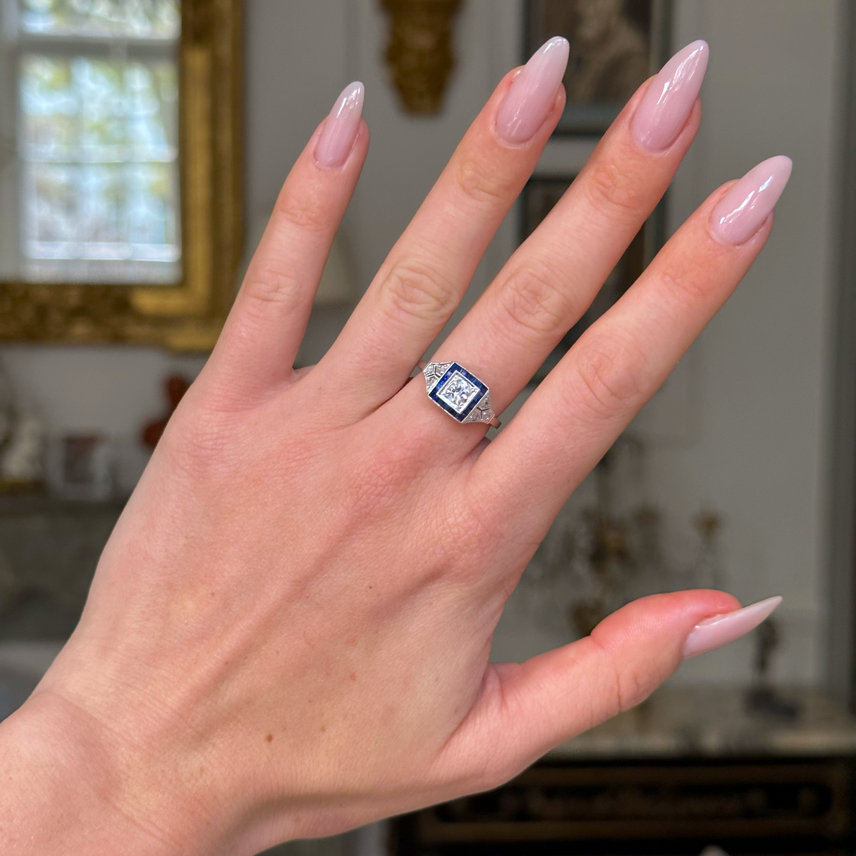 Vintage sapphire and diamond engagement ring, worn on hand.