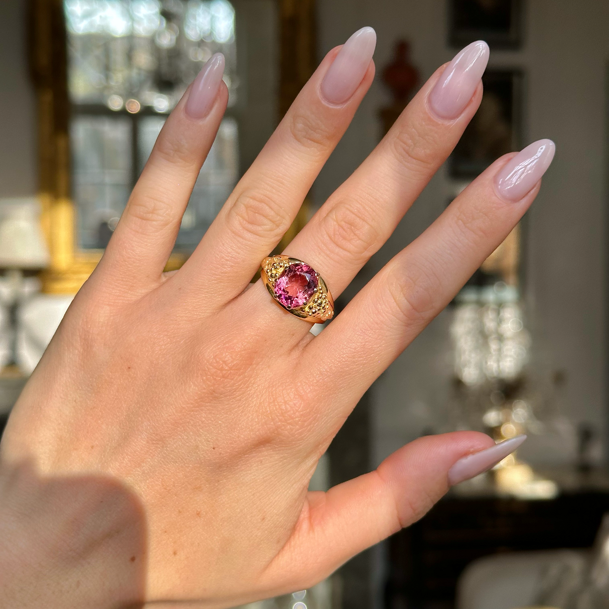 Victorian antique pink tourmaline ring worn on hand.