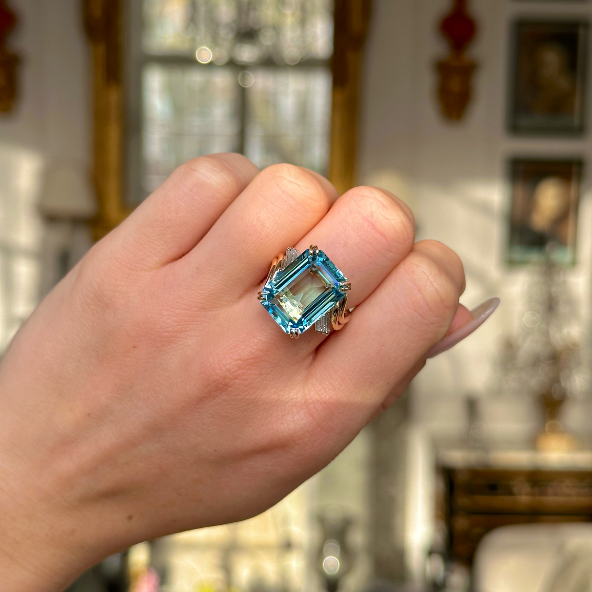 vintage aquamarine and diamond ring worn on closed hand.