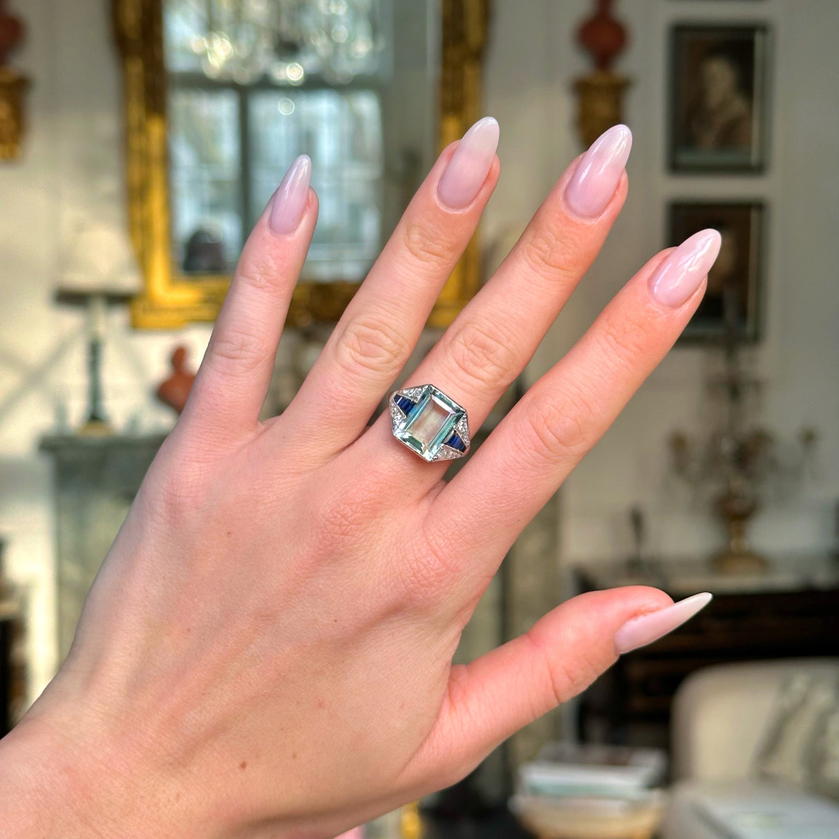 Vintage aquamarine,sapphire and diamond ring worn on hand.
