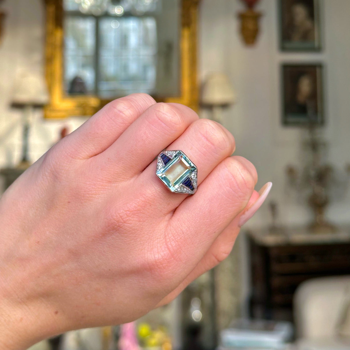 Vintage aquamarine,sapphire and diamond ring worn on closed hand.