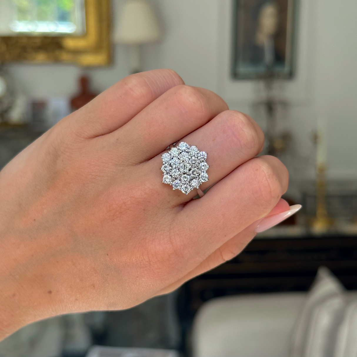 Vintage, large diamond cluster ring worn on closed hand.