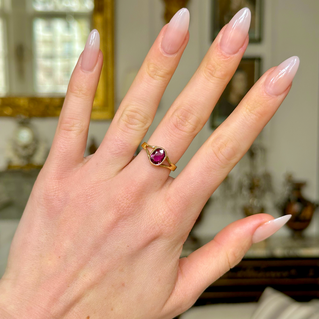 Vintage single-stone ruby and yellow gold ring, worn on hand. 