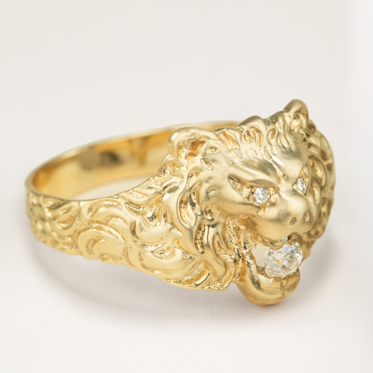 Vintage 1950s old-cut diamond lion’s head ring with diamond-set eyes placed at a 45 degree angle to display the fine details