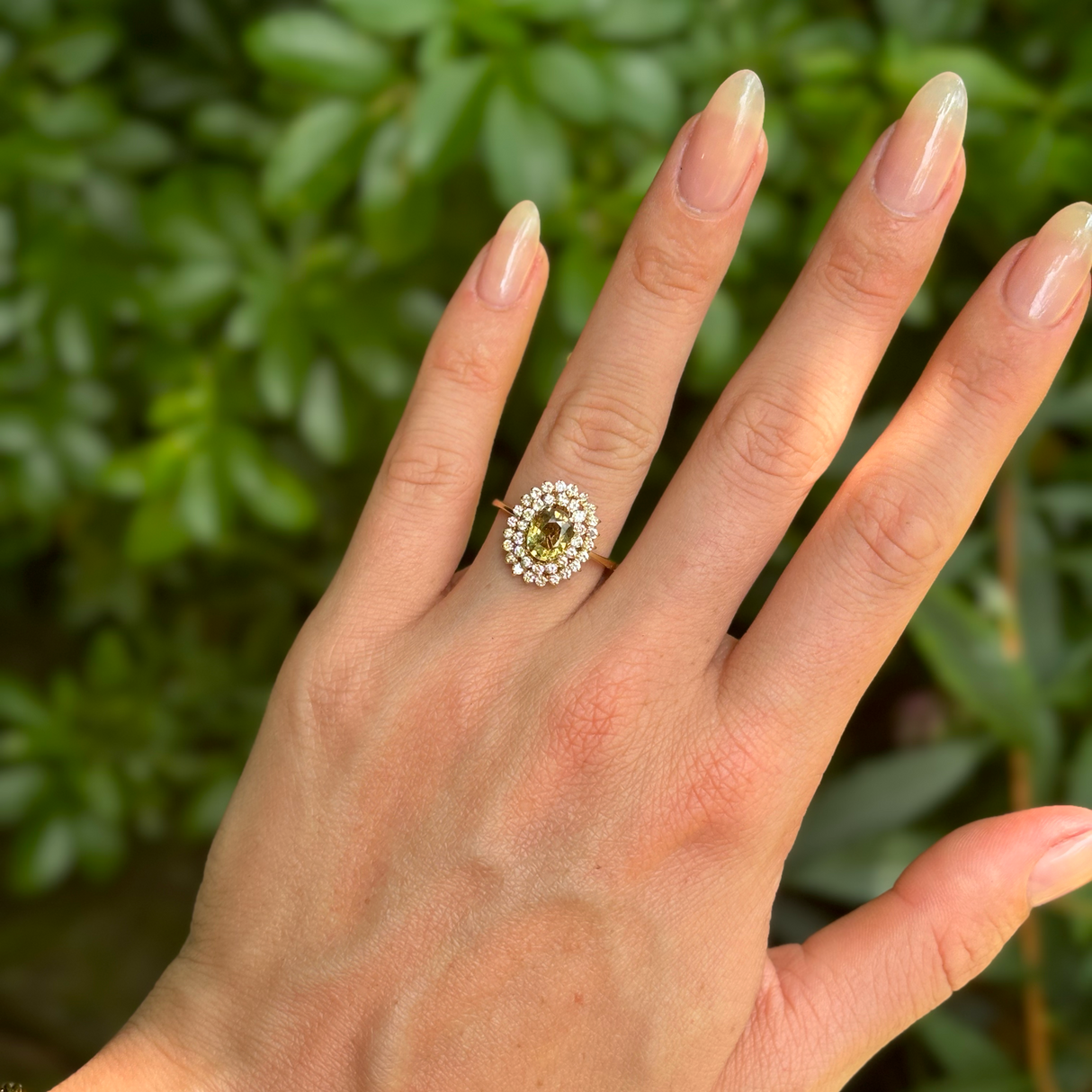 Vintage, 1950s green sapphire and diamond cluster ring, 18ct yellow gold worn on hand.