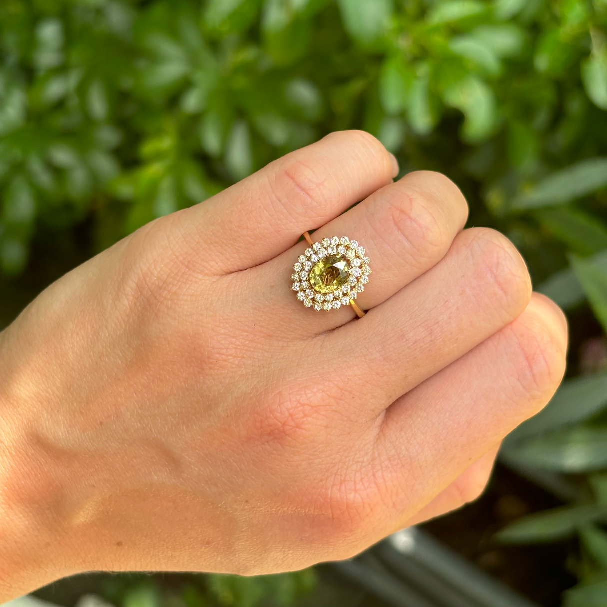 Vintage, 1950s green sapphire and diamond cluster ring, 18ct yellow gold worn on hand.