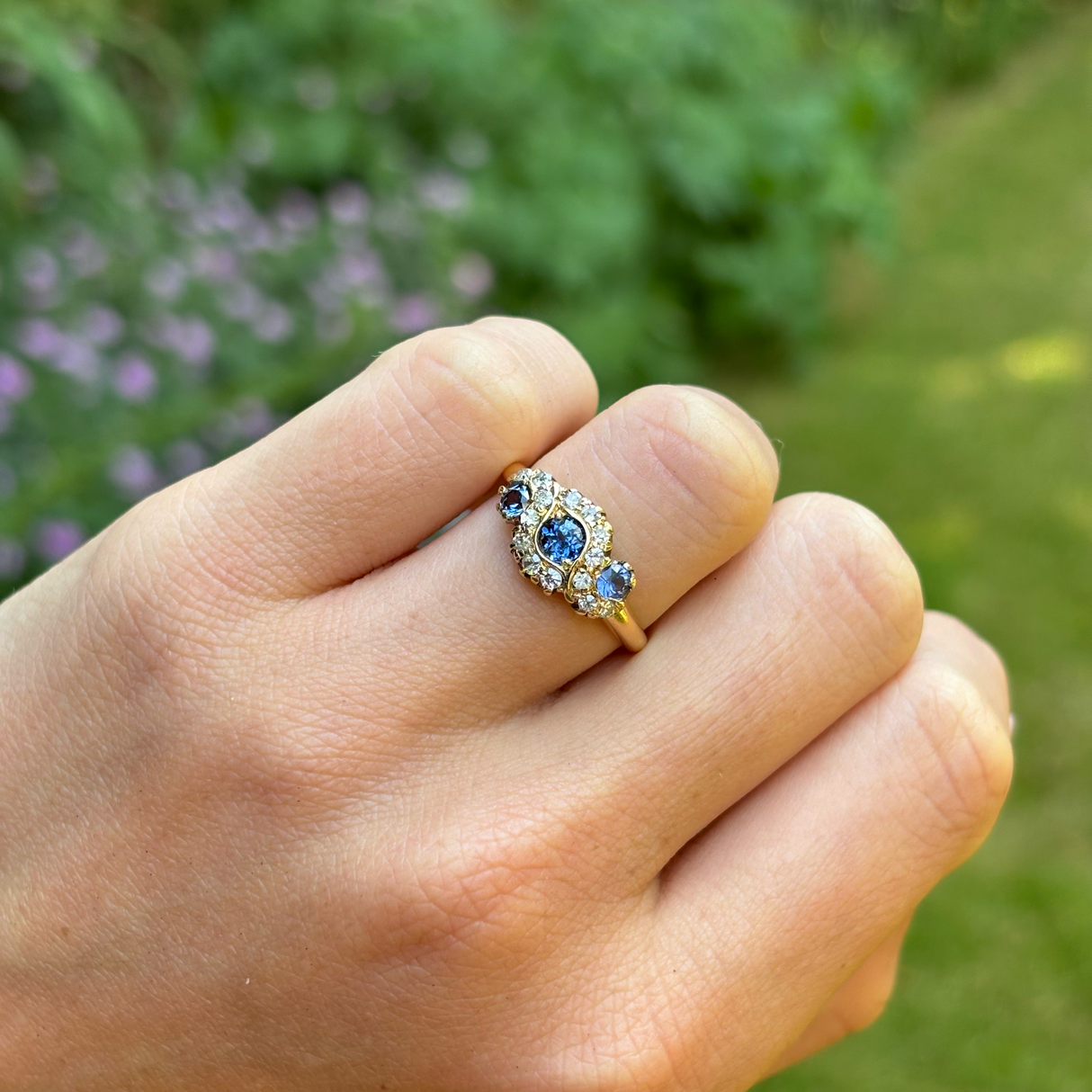 Vintage, 1950s sapphire and diamond cluster ring, 18ct yellow gold worn on hand