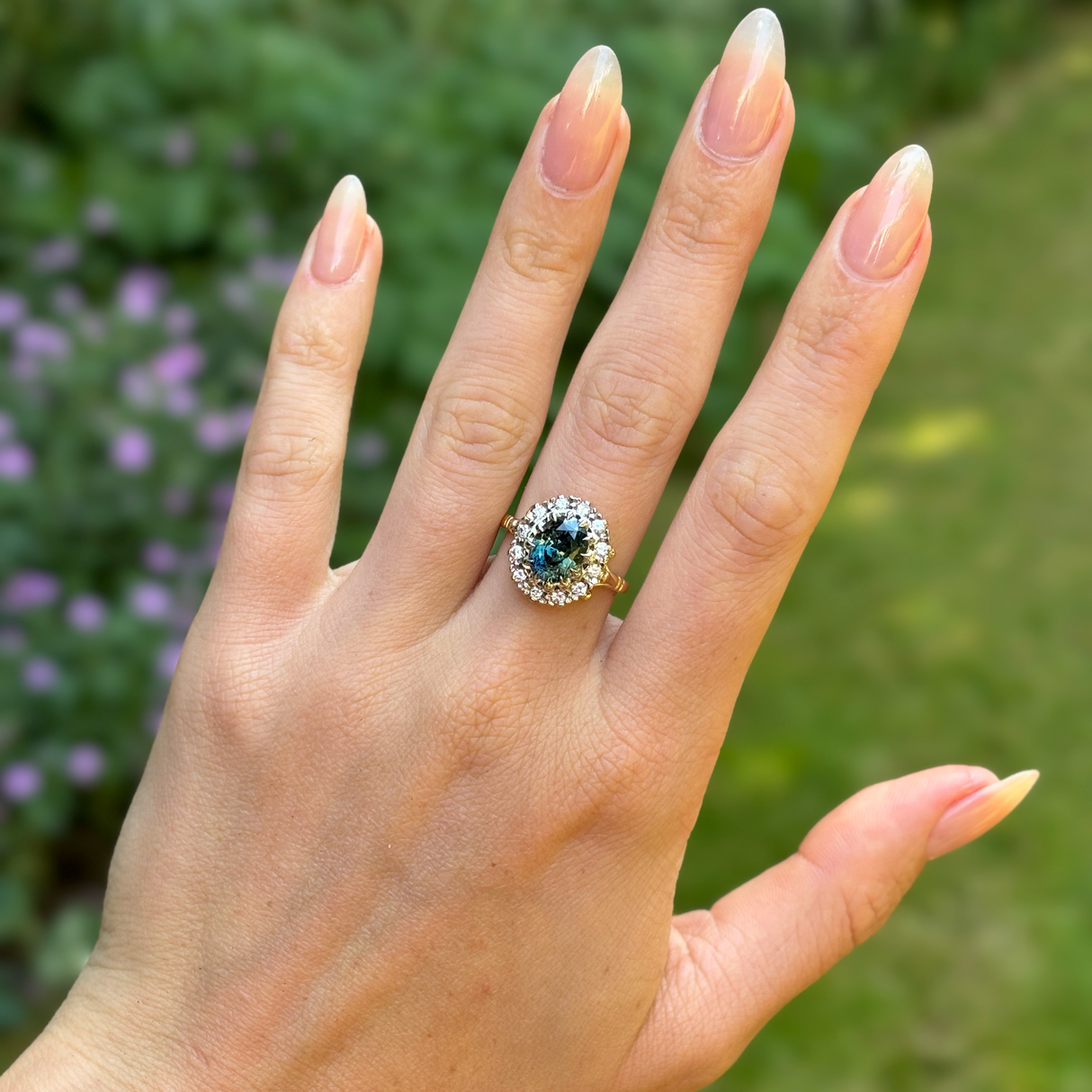 Vintage, 1970s teal sapphire and diamond cluster, 18ct yellow gold and platinum worn on hand.
