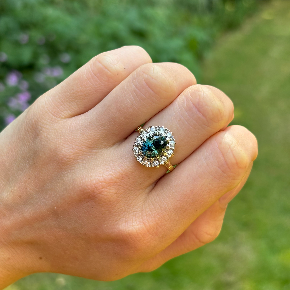 Vintage, 1970s teal sapphire and diamond cluster, 18ct yellow gold and platinum worn on hand.