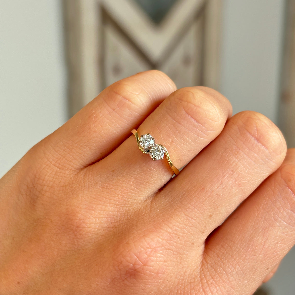 Vintage, 1980s toi et moi diamond twist ring worn on hand.