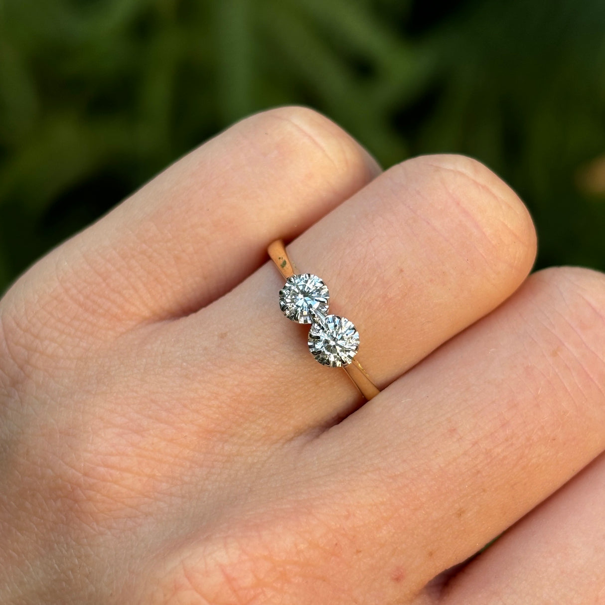 Vintage, 1990s diamond engagement ring worn on hand.