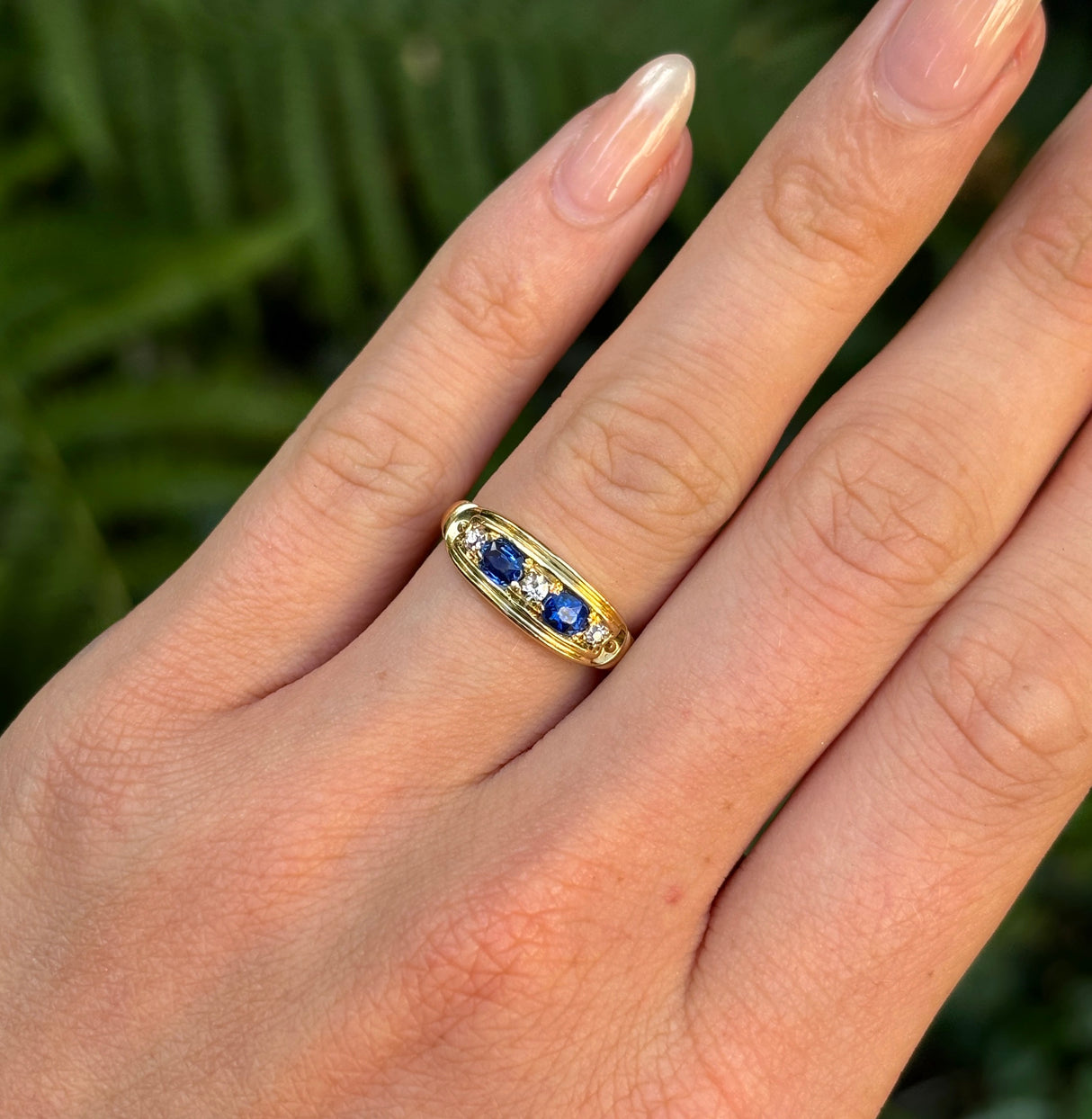 Vintage, Art Deco sapphire & diamond five-stone ring worn on hand.