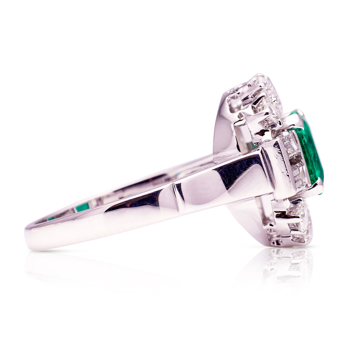 Vintage emerald and diamond cluster ring, side view.