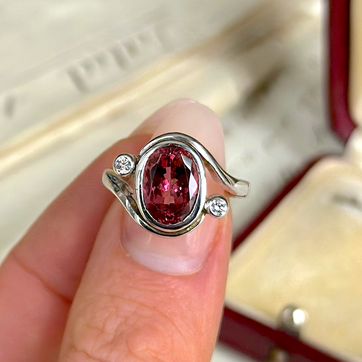 Vintage, Pink Tourmaline and Diamond Ring, 18ct White Gold held in fingers.