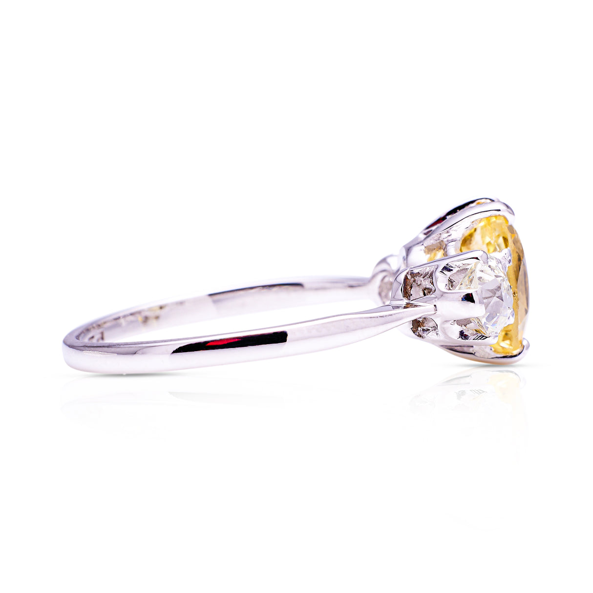 yellow sapphire and diamond three stone engagement ring, side view.