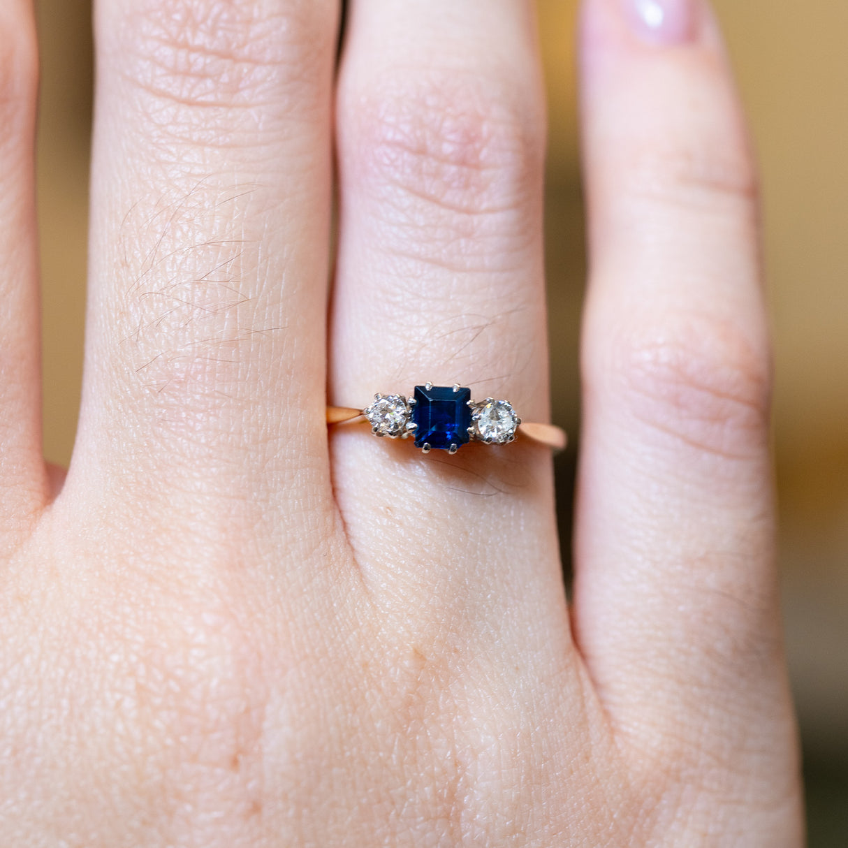 Close detail of antique 1920s sapphire and diamond three-stone ring.