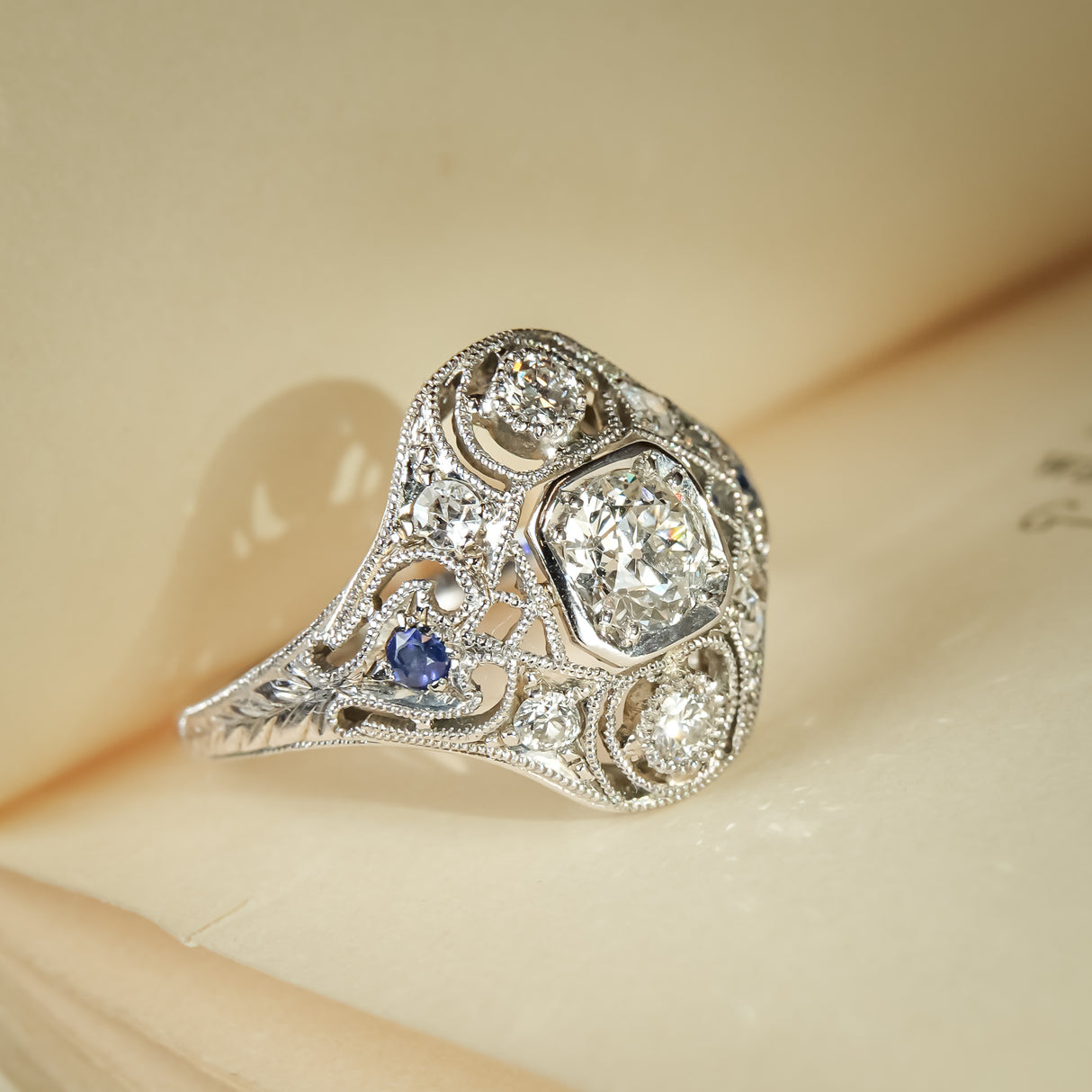 Antique Art Deco diamond ring with sapphire cluster accents