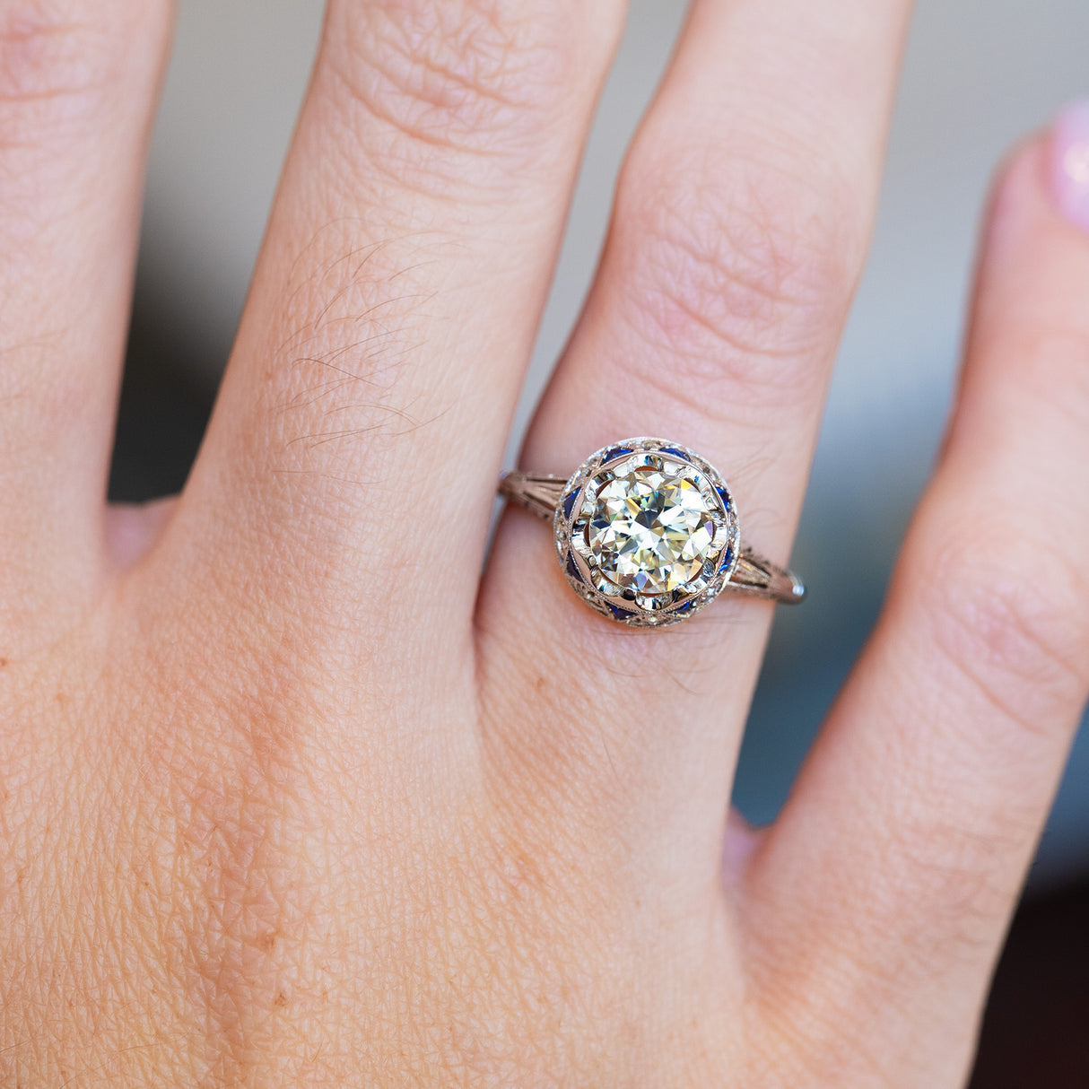 Antique Art Deco ring showing central diamond and surrounding cluster detail.