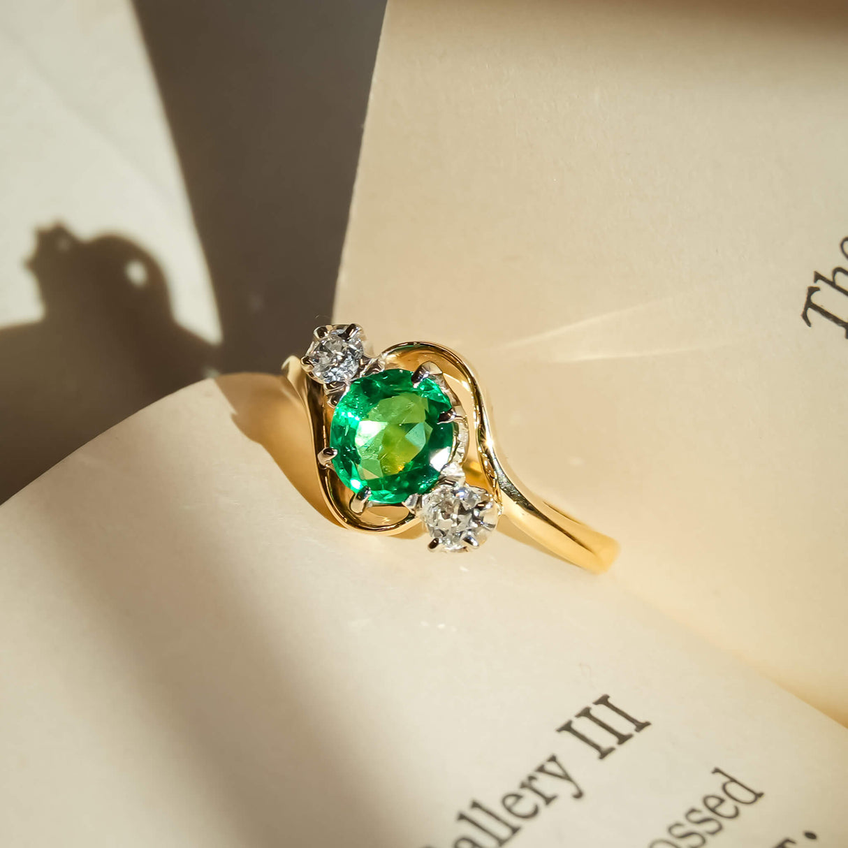 Antique Edwardian ring with emerald center and diamond side stones