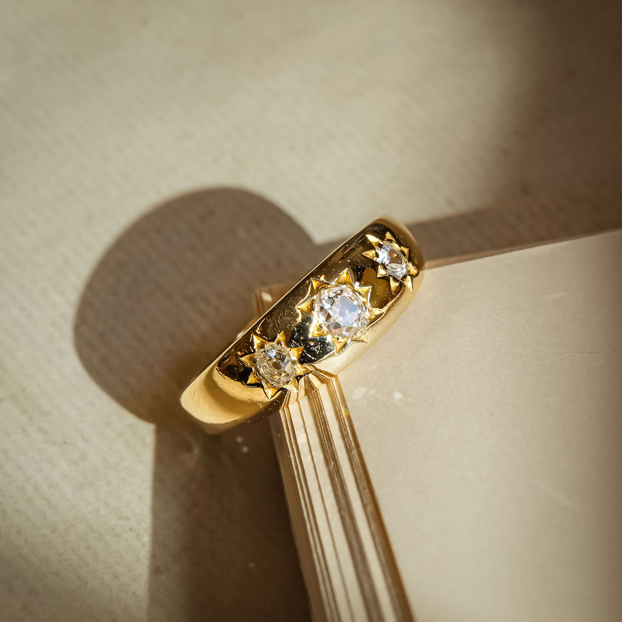 Antique Edwardian old mine cut diamond gypsy ring with star set diamonds in gold band