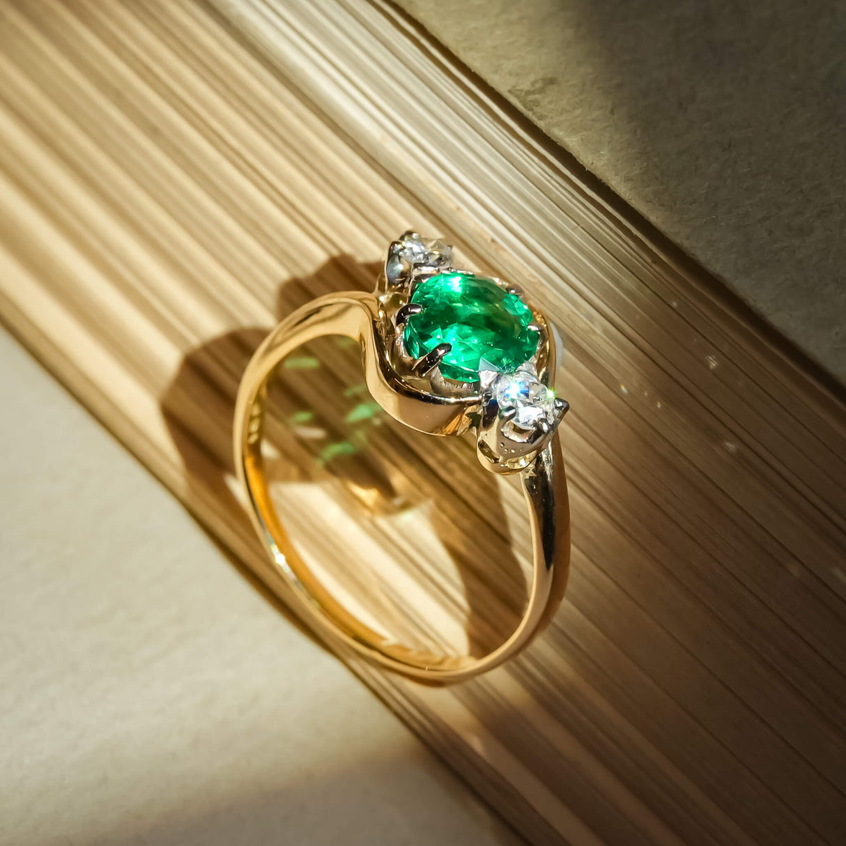 Antique emerald and diamond three stone ring in gold setting