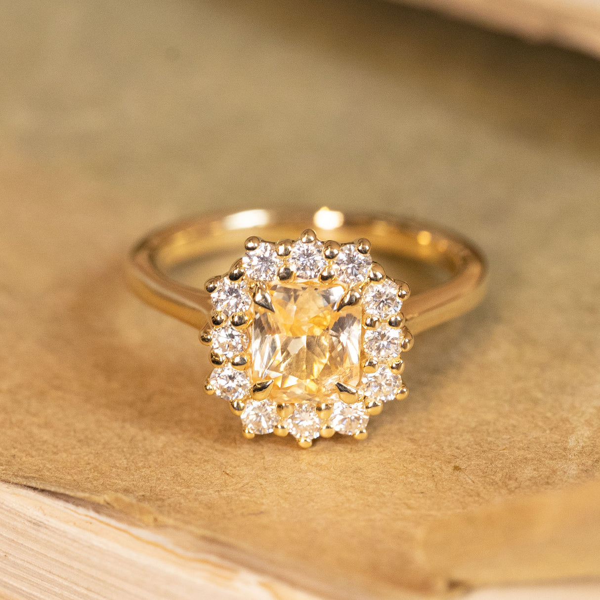 Antique-inspired yellow sapphire and diamond cluster ring showcasing a luminous yellow sapphire framed by sparkling diamonds.