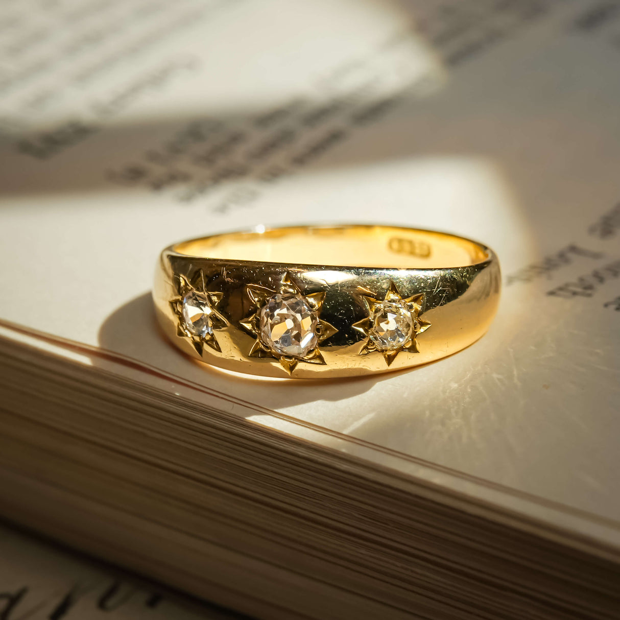 Antique Edwardian gypsy ring with old mine cut diamonds in star set gold band