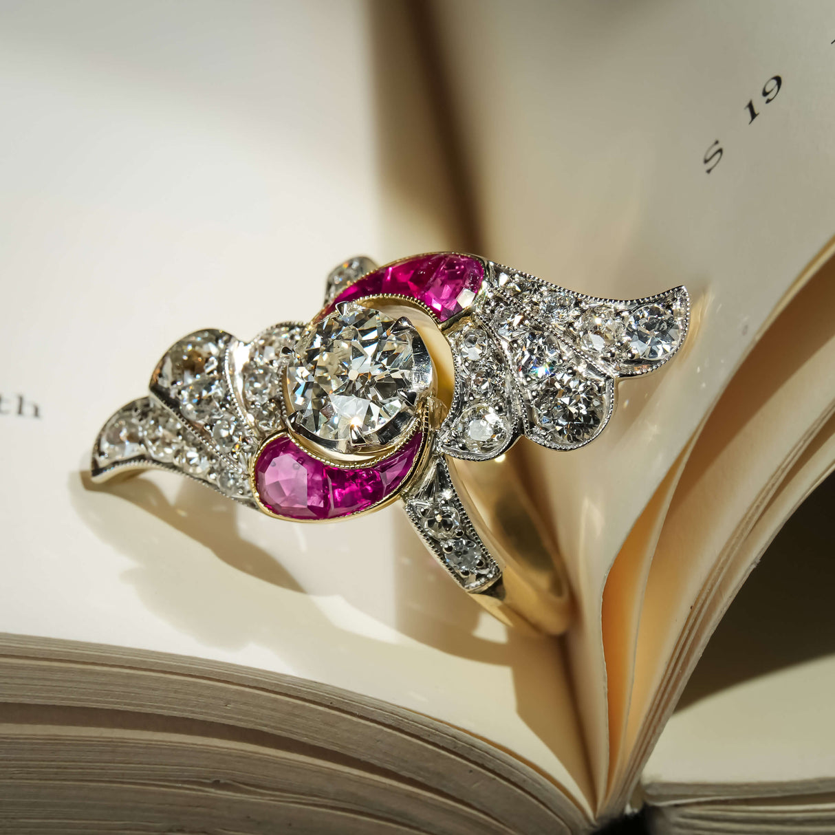 Antique Art Nouveau ring with central diamond and ruby accents with diamond set design