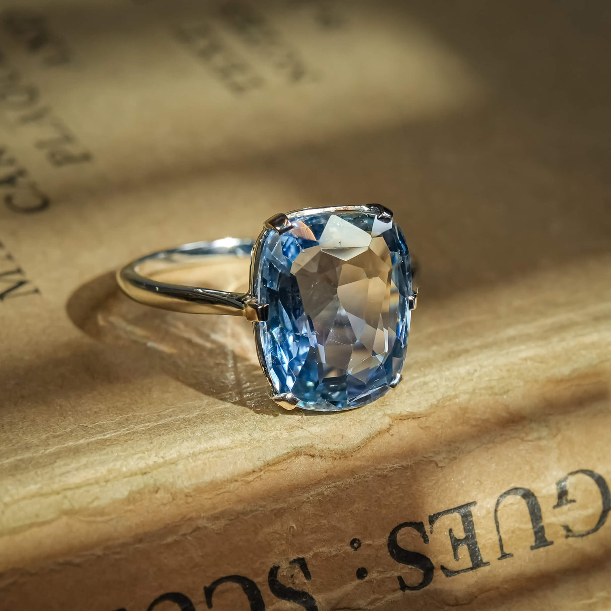 Antique 1920s sapphire solitaire ring featuring cushion cut blue gemstone