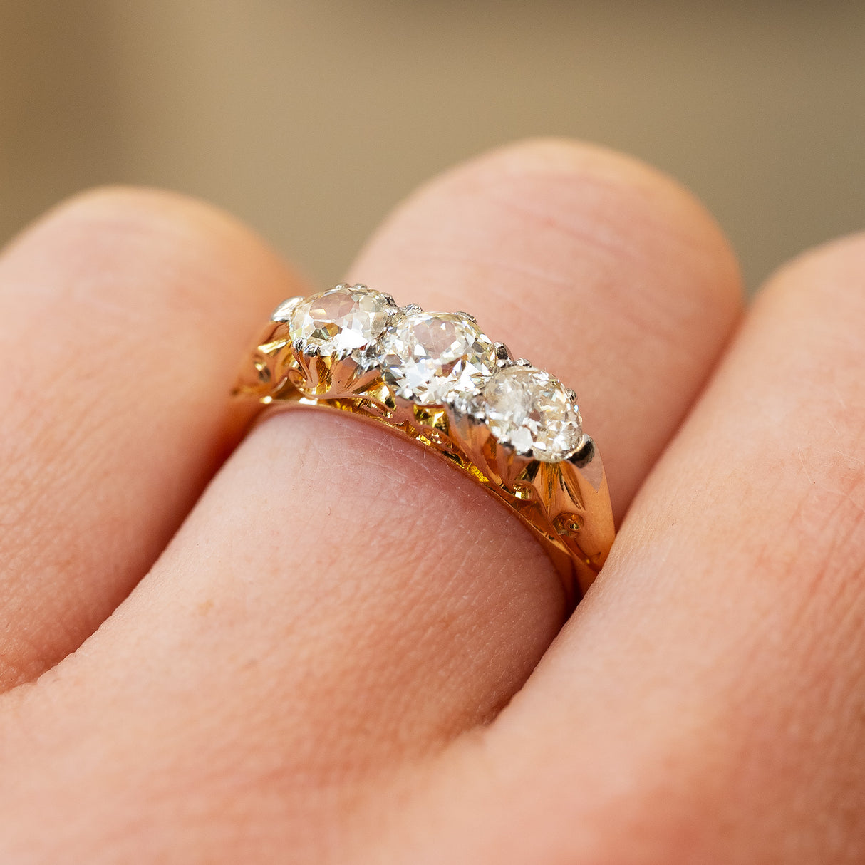 Antique diamond ring showing gold setting and detailed work.