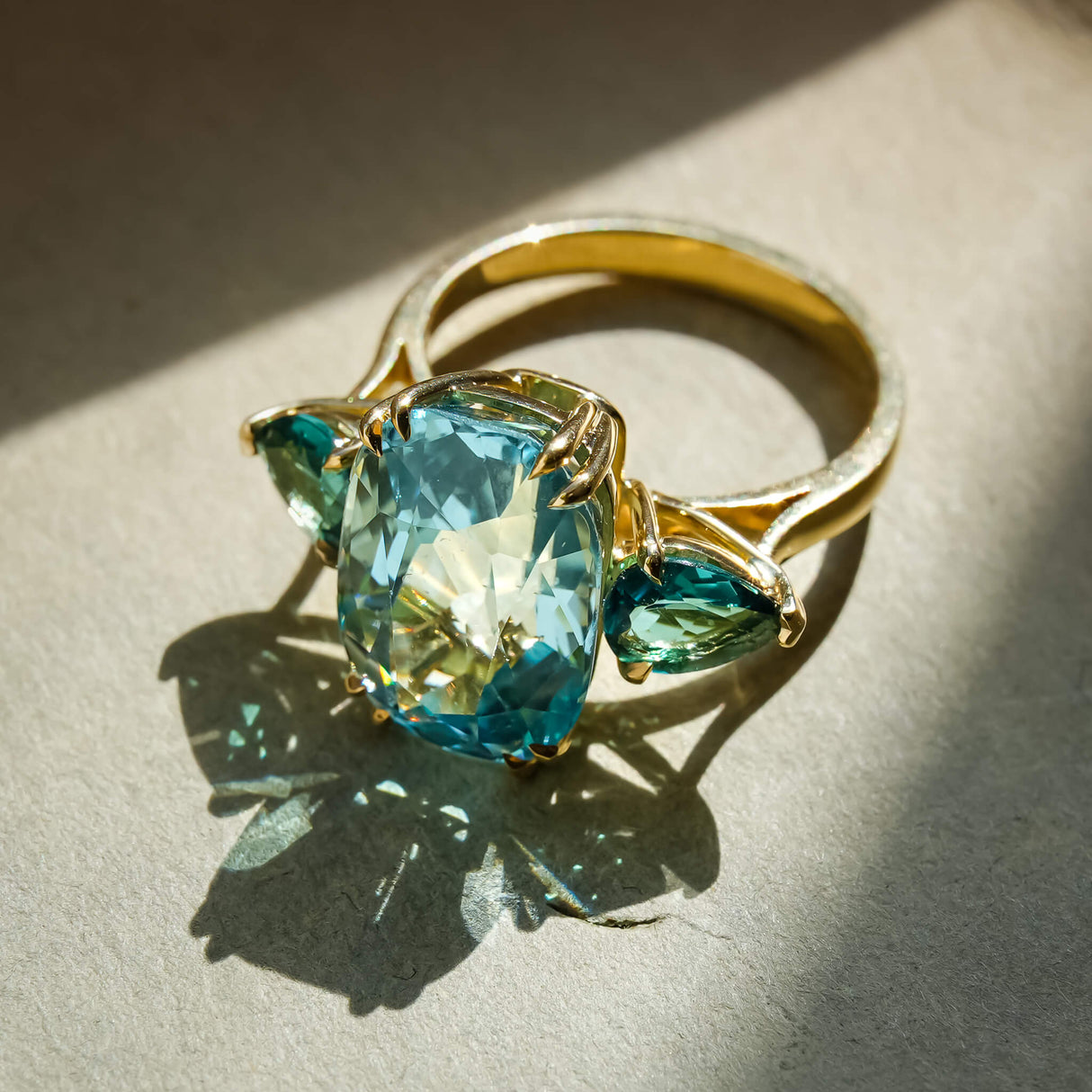 Aquamarine three stone ring with sea green tourmaline side gemstones