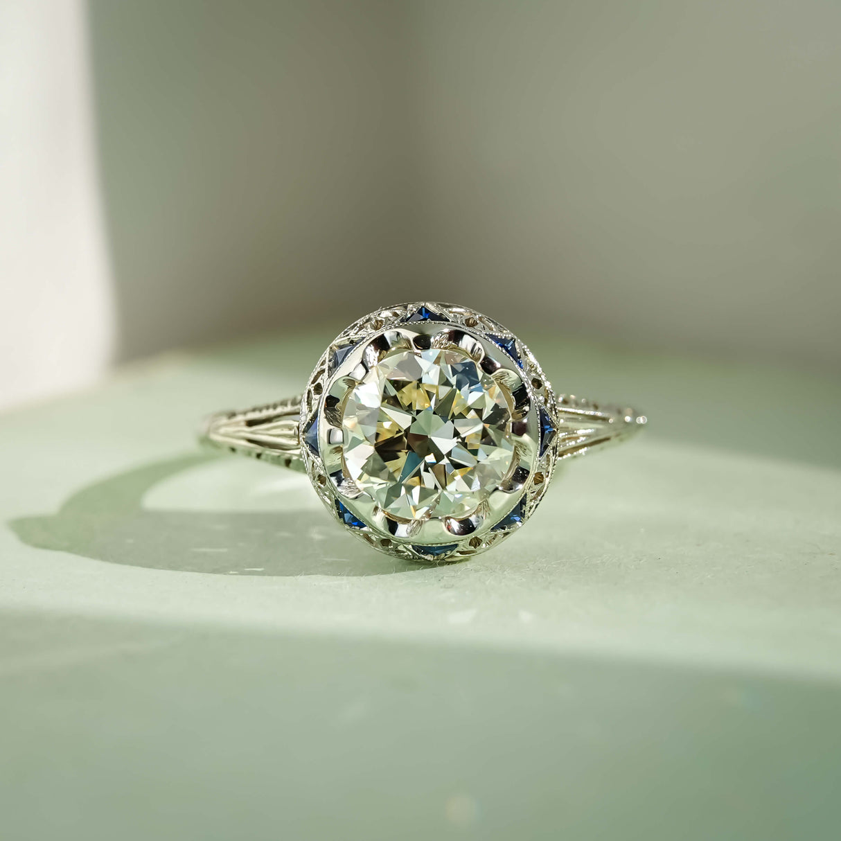 art deco diamond cluster ring with sapphire accents in white gold